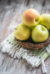 Apples in a basket on rustic background
