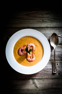 Shrimp soup with mussels on rustic background