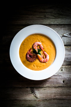 Shrimp soup with mussels on rustic background