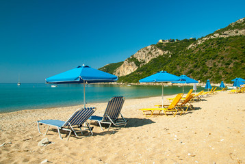 Fototapeta na wymiar Sunbeds and umbrellas on the beach. Corfu Island - Greece