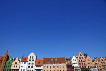 Fototapeta na wymiar Colourful old buildings with blue sky background in Gdansk