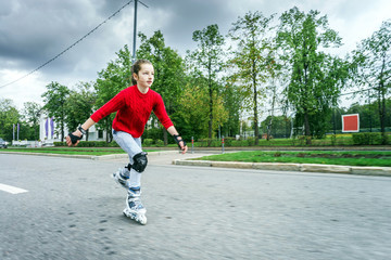 Beautiful teenage girl roller-skating