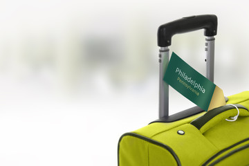 Fototapeta premium Philadelphia, Pennsylvania. Green suitcase with label.