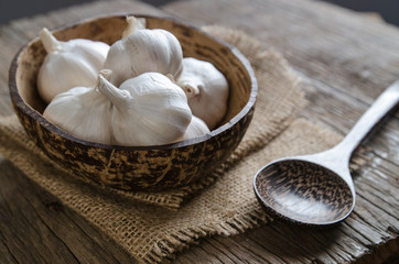 Garlic in coconut shell with sack cloth and spoon