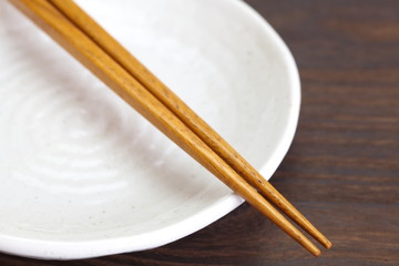 Close - up brown wooden chopsticks on table wood background