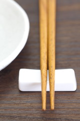 Close - up brown wooden chopsticks on table wood background