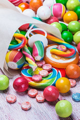 Fototapeta na wymiar multicolored sweets and chewing gum in paper bags