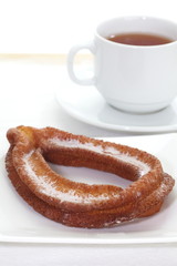 doughnuts with icing sugar and hot tea