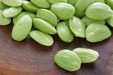 Pile of parkia on grunge wooden background.