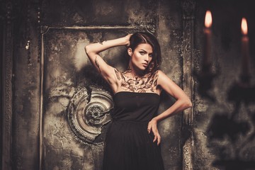 Tattooed beautiful woman in old spooky interior