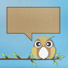 Owl perched paper craft on paper background.