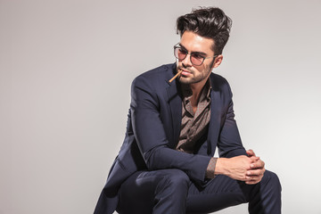 business man with cigarette in his mouth looking to  side