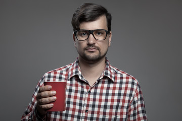 Handsome hipster modern man and cup of coffee in hand.