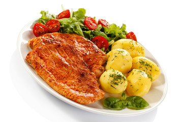 Fried pork chop, boiled potatoes and vegetable salad
