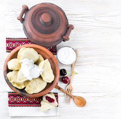 Ukrainian dumplings with cabbage, cheese and cherries