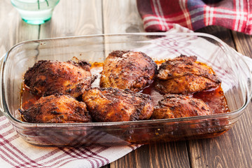 Roasted chicken drumsticks in casserole dish