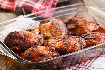 Roasted chicken drumsticks in casserole dish