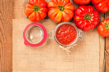 Tomatoes and tomato sauce, tomato puree on a wooden rustic table