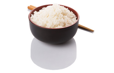 A bowl of rice and a pair of chopstick over white background