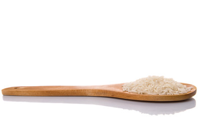 Raw and uncooked rice in wooden spoon over white background