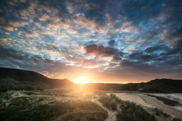 Beautiful Summer sunrise landscape over yellow sandy beach