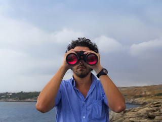 boy with binoculars scanned the horizon