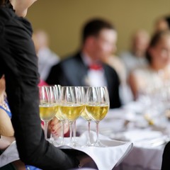 Waitress with dish of champagne glasses
