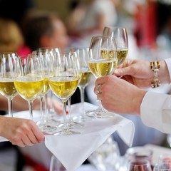 Waitress with dish of champagne glasses