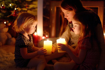 Happy family by a fireplace on Christmas