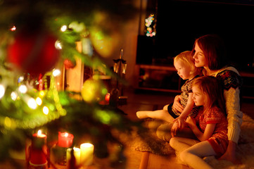 Happy family by a fireplace on Christmas