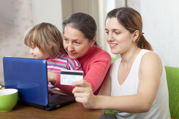 Fototapeta na wymiar Women and child doing shopping in internet