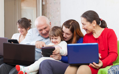Happy family uses electronic devices