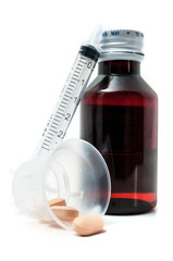 Bottle of medicine, pills and syringe isolated on white