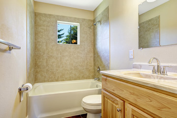 Empty bathroom with tile wall trim and window