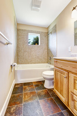 Empty bathroom with tile wall trim and window