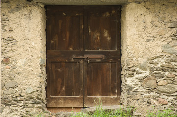 Barn door of wood secured with padlock