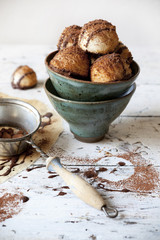homemade coconut macaroons with dripped dark chocolate on bowl