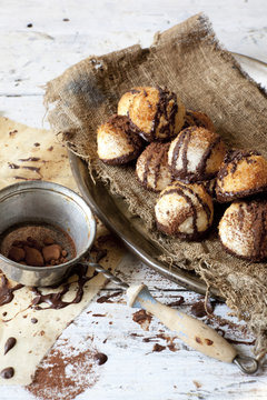coconut macaroons with dripped chocolate and vintage strainer