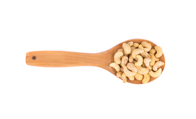 Cashew nuts in wooden spoon.