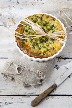 vegetables french quiche with peas on baking dish