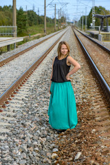 Standing girl between two railway path
