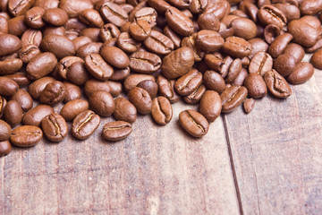 Coffee seeds on wooden surface texture. 