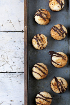coconut macaroons with dripped chocolate on vintage tray