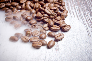Coffee seeds on wooden surface texture. 
