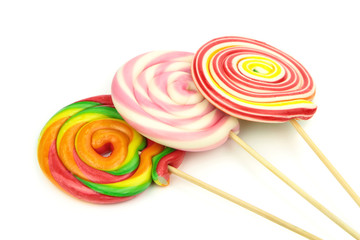 Colorful spiral lollipops on white background