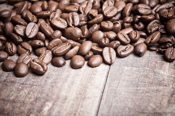 Coffee seeds on wooden surface texture. 