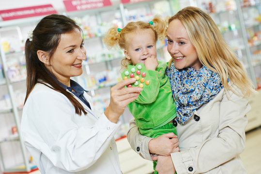 Pharmacy chemist, mother and child in drugstore