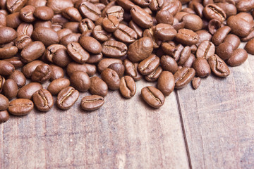 Coffee seeds on wooden surface texture. 
