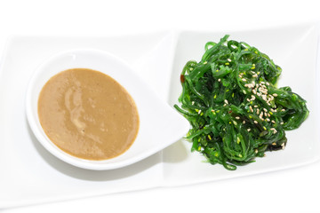 seaweed salad and wasabi sauce on a white background