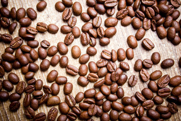 Coffee seeds on wooden surface texture. 